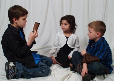 boy reading to others