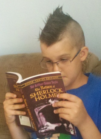 boy reading sherlock holmes book